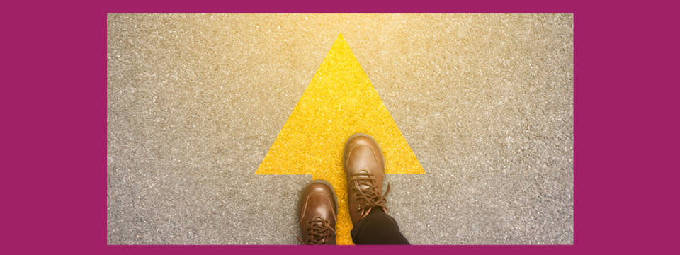 Feet on top of a yellow arrow pointing up.
