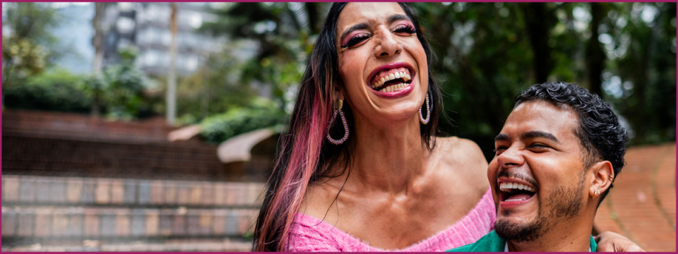 Two people walking together, embracing, and laughing.