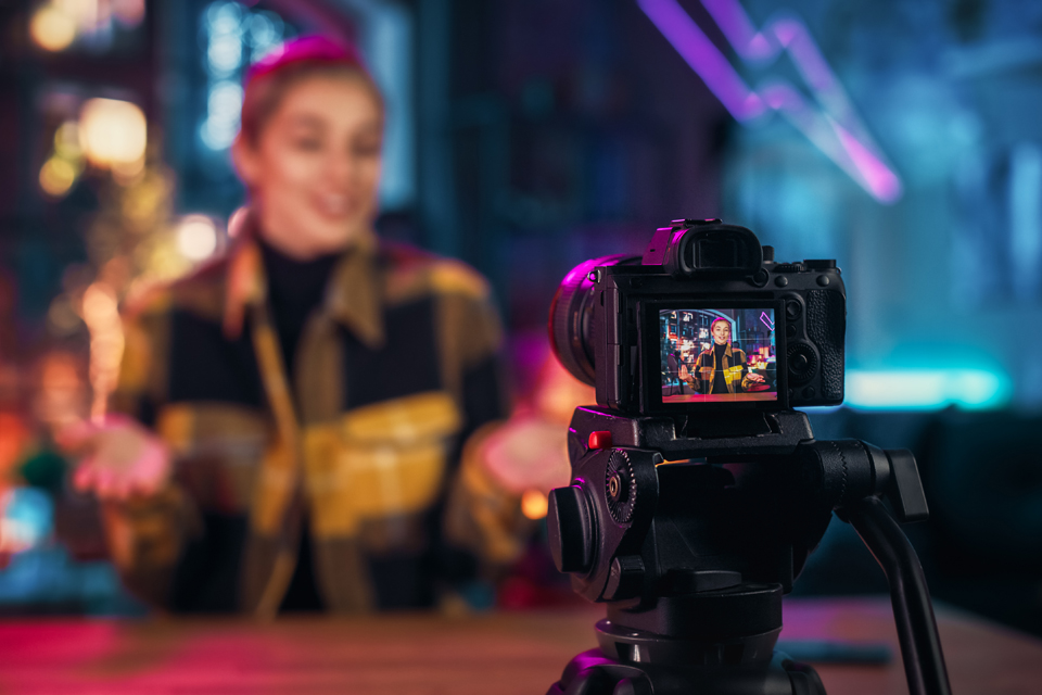 Woman talking in front of camera.